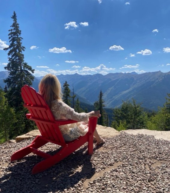 Debi taking in the view of the Aspen, Colorado mountains that inspired Wilderwhim Woods